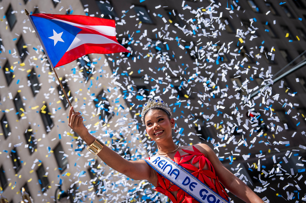 A person participates in the National Puerto Rican Day Parade, Sunday, June 14, 2026 in New York. (AP Photo/Adam Gray)