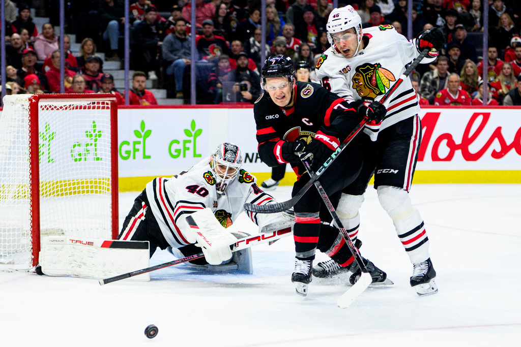 Ottawa Senators' Brady Tkachuk (7) chases down the puck while under pressure from Chicago Blackhawks' Louis Crevier (46) during second-period NHL hockey game action in Ottawa, Ontario, Saturday, Dec. 20, 2025. (Spencer Colby/The Canadian Press via AP)