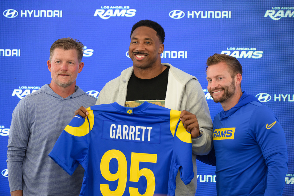 From left, Los Angeles Rams general manager Les Snead, left, defensive end Myles Garrett, and head coach Sean McVay pose for a photo during a press conference following the NFL football team's practice, Tuesday, June 2, 2026, in Woodland Hills, Calif. (AP Photo/Kyusung Gong)