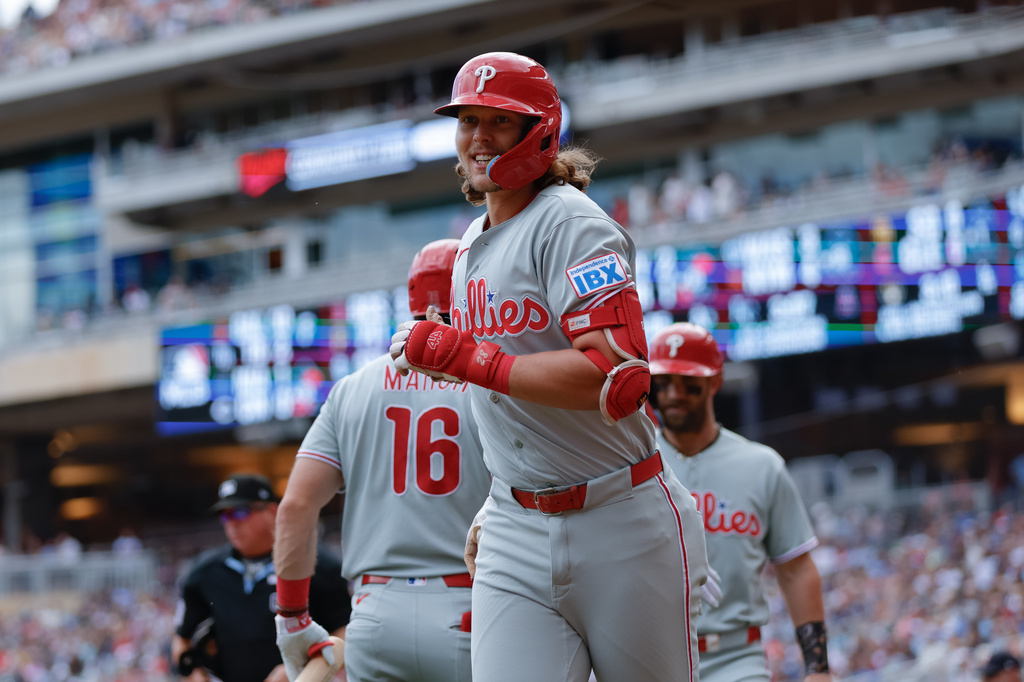 Philadelphia Phillies' Alec Bohm, center, celebrates after hitting a three-run home run during the sixth inning of a baseball game against the Minnesota Twins, Sunday, Aug. 16, 2026, in Minneapolis. (AP Photo/Bailey Hillesheim)