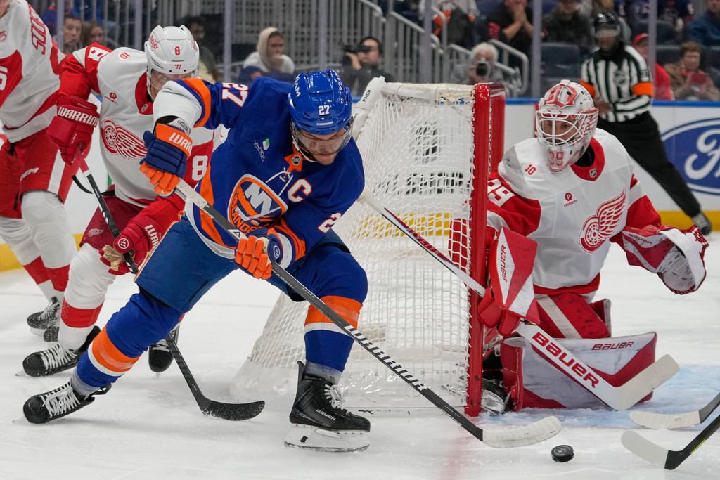 Detroit Red Wings goaltender Cam Talbot (39) stops a shot by New York Islanders' Anders Lee (27) during the second period of an NHL hockey game Thursday, Oct. 23, 2025, at UBS Arena in Elmont, N.Y. (AP Photo/Frank Franklin II)