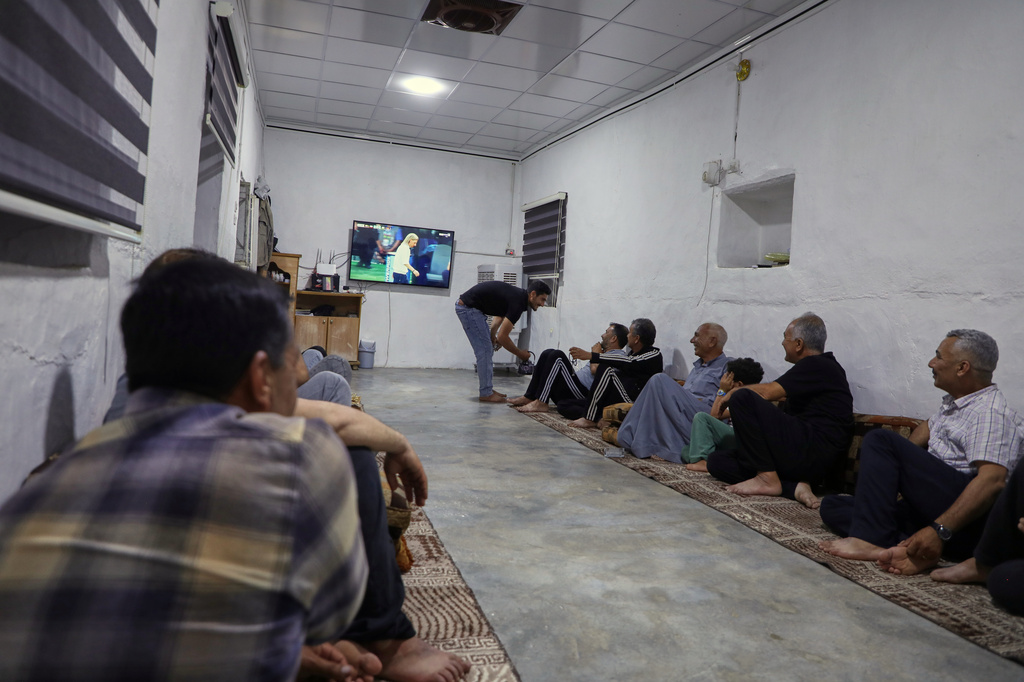 A small group of Yazidis gather to watch the Germany-Ecuador match at the home of community leader Ismail Dalaf in Khirbet al-Ghazal, northeastern Syria, late Thursday, June 25, 2026.(AP Photo/Hogir Al Abdo)