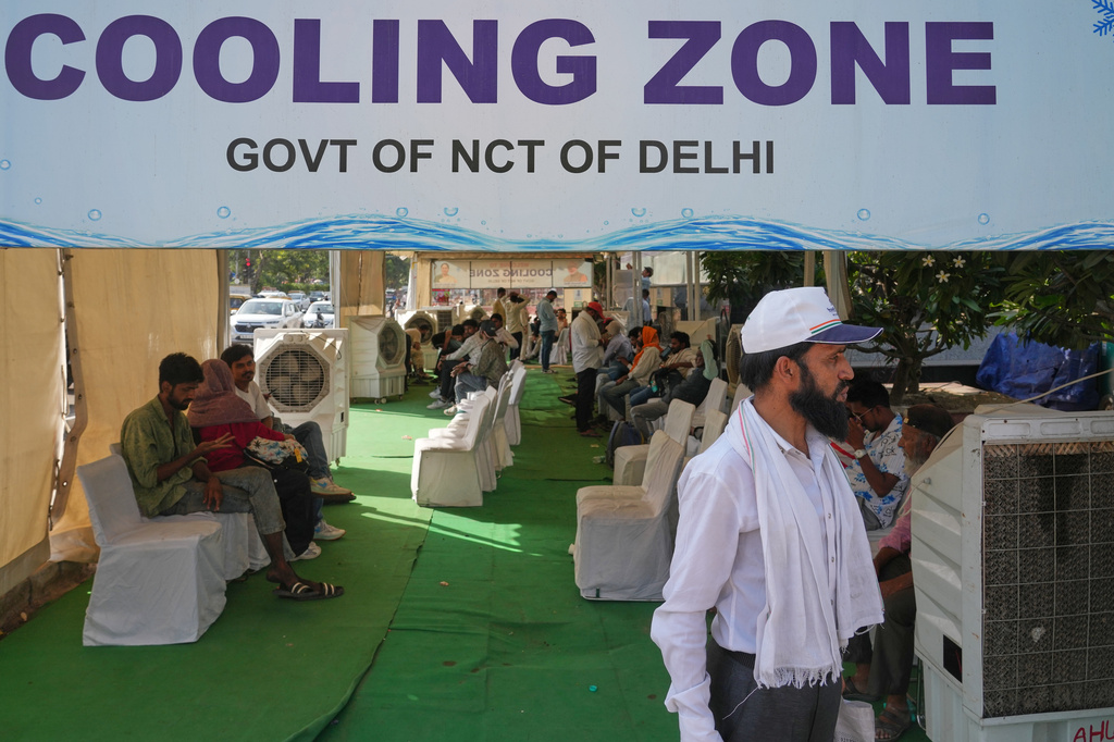 Commuters rest at a roadside cooling station set up by the government to provide relief for people from the intense summer heat in New Delhi, India, Wednesday, May 20, 2026. (AP Photo/Manish Swarup)