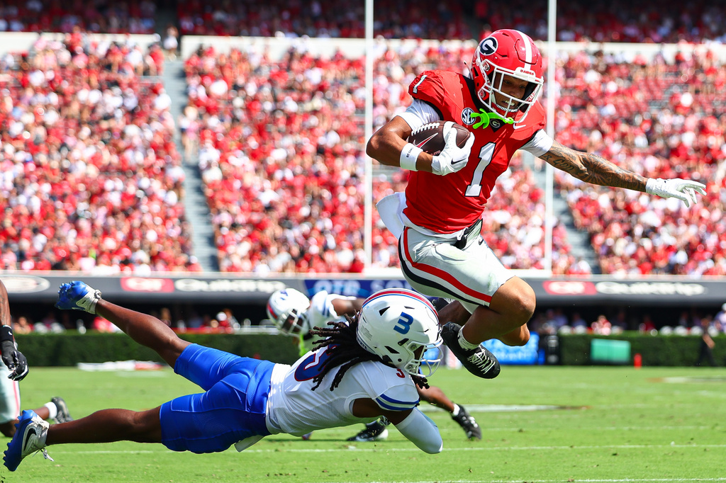 Georgia wide receiver Talyn Taylor (1) hurdles Tennessee State defensive back Mikeece Jones (3) before scoring a touchdown during the first half of an NCAA college football game, Saturday, Sept. 5, 2026, in Athens, Ga. (AP Photo/Colin Hubbard)