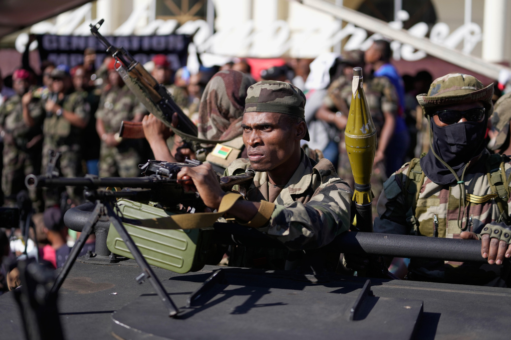 Troops loyal to CAPSAT military unit commander Col. Michael Randrianirina joins protesters to announce that the armed forces are taking control of the country in Antananarivo, Madagascar, Tuesday, Oct. 14, 2025. (AP Photo/Brian Inganga)
