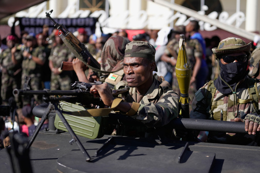 Troops loyal to CAPSAT military unit commander Col. Michael Randrianirina joins protesters to announce that the armed forces are taking control of the country in Antananarivo, Madagascar, Tuesday, Oct. 14, 2025. (AP Photo/Brian Inganga) Troops loyal to CAPSAT military unit commander Col. Michael Randrianirina joins protesters to announce that the armed forces are taking control of the country in Antananarivo, Madagascar, Tuesday, Oct. 14, 2025. (AP Photo/Brian Inganga)