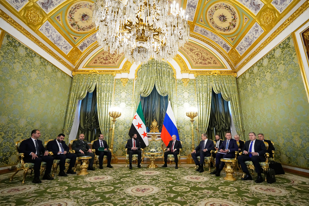 Russian President Vladimir Putin, centre right, and Syrian interim President Ahmad al-Sharaa talk during their meeting at the Grand Kremlin Palace in Moscow, Russia, Wednesday, Oct. 15, 2025. (AP Photo/Alexander Zemlianichenko, Pool)