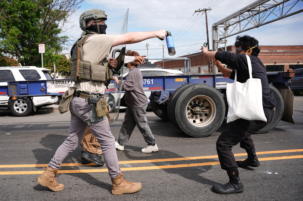 Federal immigration officers confront protesters outside the Delaney Hall detention center Thursday, May 28, 2026, in Newark, N.J. (AP Photo/Angelina Katsanis)