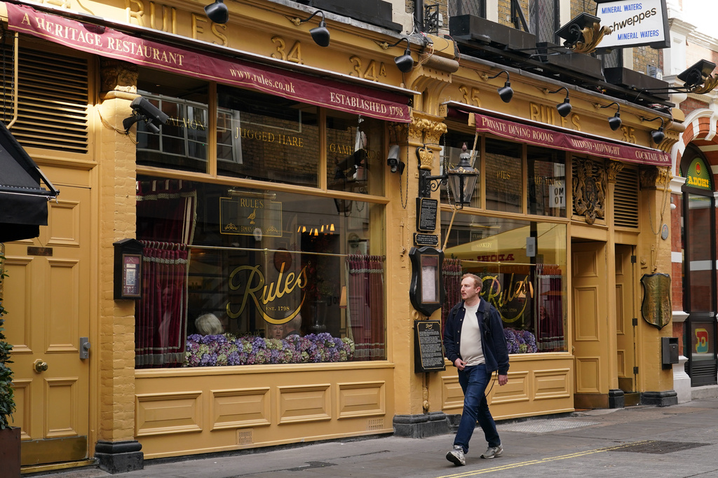 A man walks past London's oldest Restaurant ' Rules' which has been donated to Europe's biggest conservation charity in London, Wednesday, Oct. 14, 2026.(AP Photo/Alberto Pezzali)