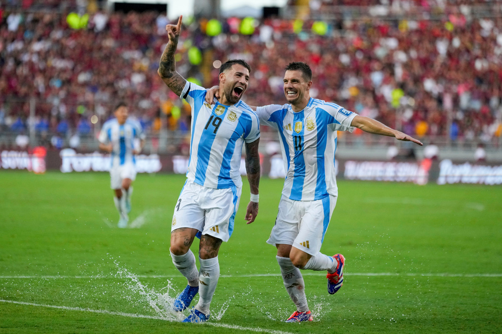 FILE - Argentina's Nicolas Otamendi (19, File) celebrates with Giovani Lo Celso after scoring his side's opening goal against Venezuela during a FIFA World Cup 2026 qualifying soccer match in Maturin, Venezuela, Thursday, Oct. 10, 2024. (AP Photo/Ariana Cubillos, File)