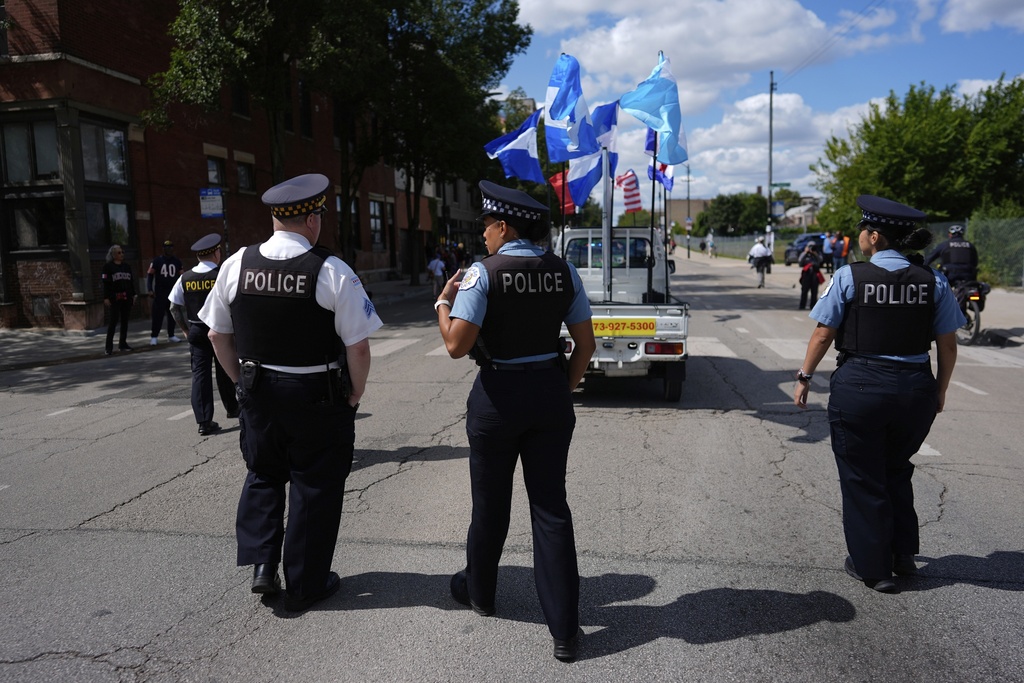 Police walk the route during the 2025 Pilsen Mexican Independence Day parade Saturday, Sept. 6, 2025, in Chicago. (AP Photo/Carolyn Kaster)