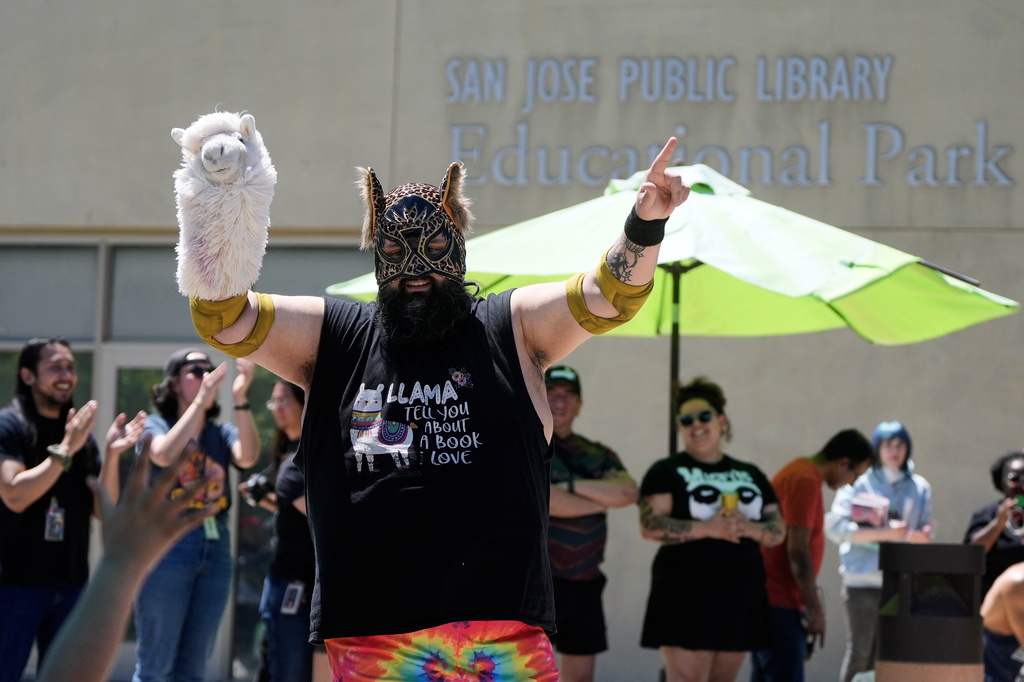 Wrestler Llama Jack gestures to fans before competing in a Lucha Libro pro wrestling match at the San Jose Public Library Educational Park Branch Saturday, May 9, 2026, in San Jose, Calif. (AP Photo/Jeff Chiu)