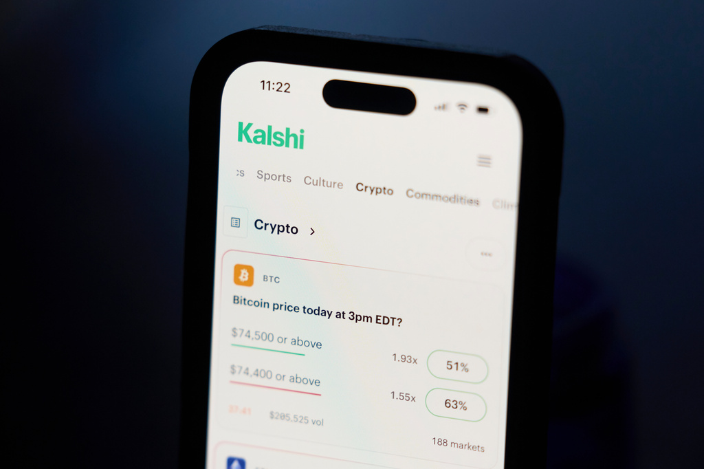 A phone displays crypto trades on Kalshi on Thursday, April 16, 2026, in Portland, Ore. (AP Photo/Jenny Kane)