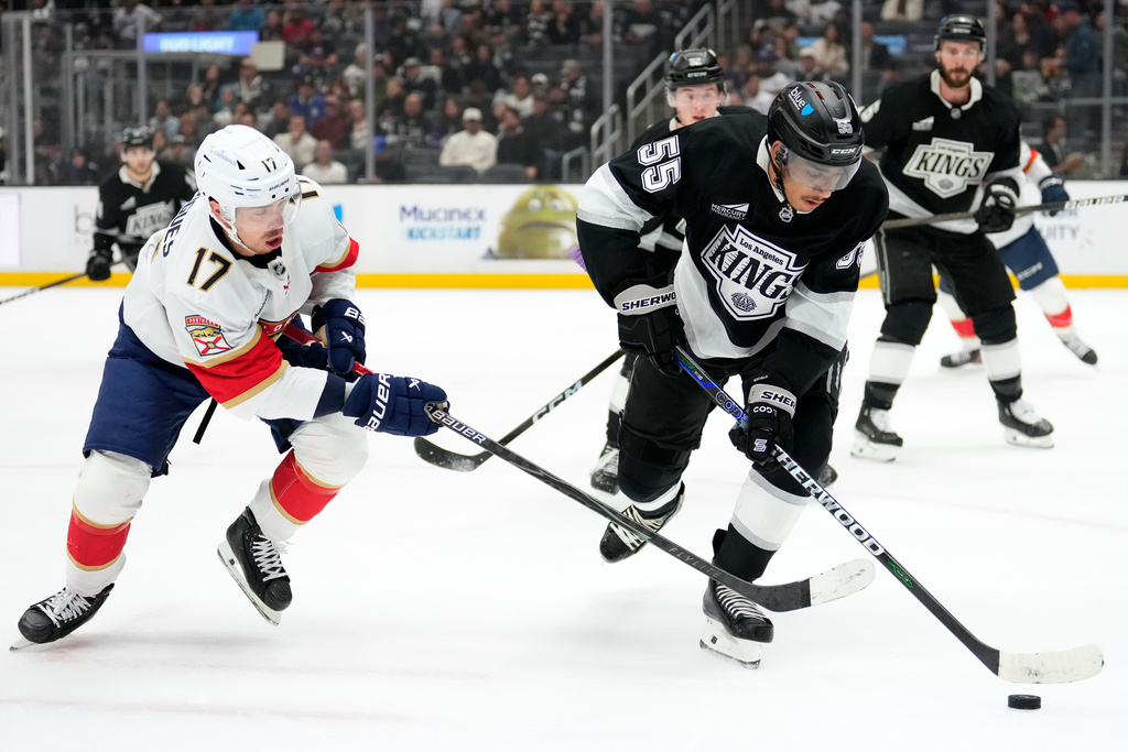 Florida Panthers center Evan Rodrigues, left, and Los Angeles Kings right wing Quinton Byfield vie for the puck during the first period of an NHL hockey game Thursday, Nov. 6, 2025, in Los Angeles. (AP Photo/Mark J. Terrill)