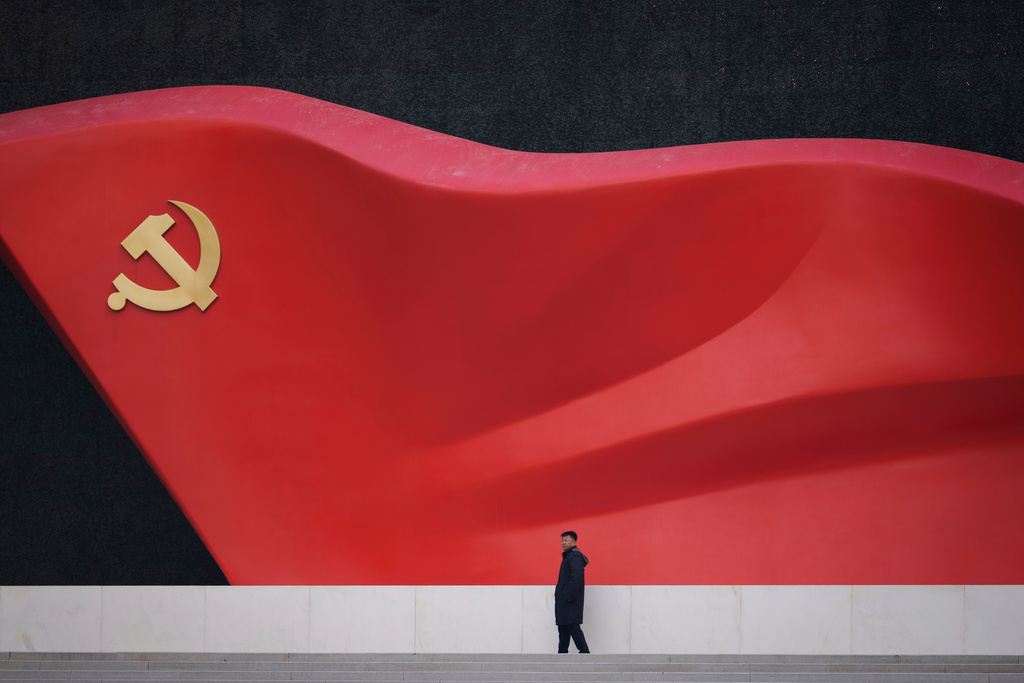 A man walks near a large sculpture of the Communist Party flag at the Chinese Communist Party History Exhibition in Beijing, China, Sunday, March 1, 2026. (AP Photo/Vincent Thian)