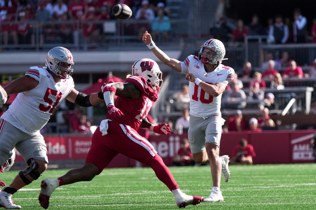 Ohio State's Julian Sayin throws a touchdown pass during the first half of an NCAA college football game against the Wisconsin Saturday, Oct. 18, 2025, in Madison, Wis. (AP Photo/Morry Gash)