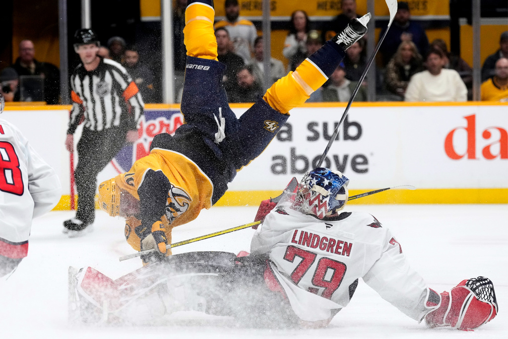 Nashville Predators center Steven Stamkos (91) flips over Washington Capitals goaltender Charlie Lindgren (79) during the second period of an NHL hockey game Sunday, Jan. 11, 2026, in Nashville, Tenn. (AP Photo/Mark Humphrey)