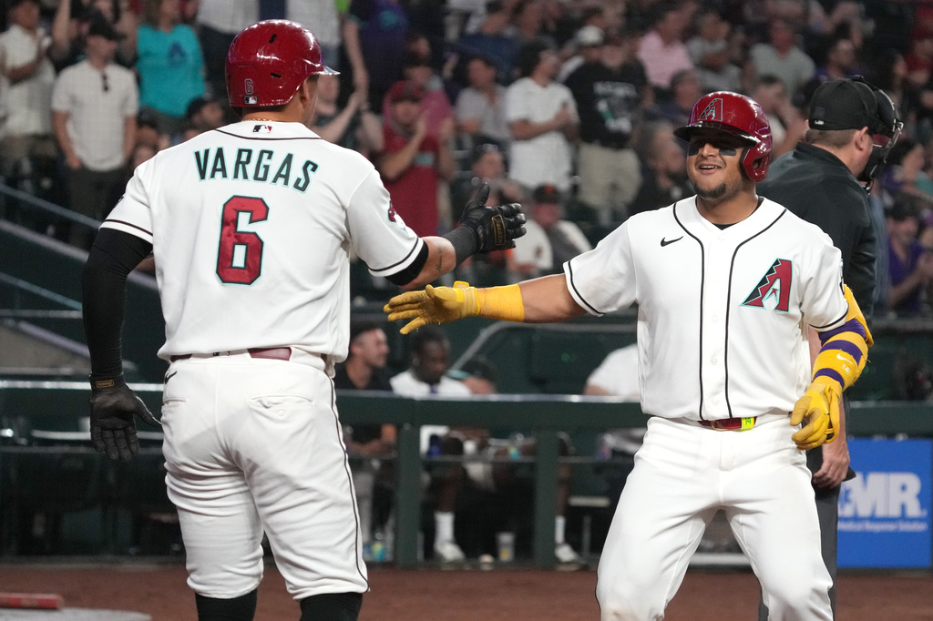 Arizona Diamondbacks' Gabriel Moreno, front right, celebrates with Ildemaro Vargas (6) after hitting a two-run home run against the San Francisco Giants in the fifth inning of a baseball game, Monday, May 18, 2026, in Phoenix. (AP Photo/Rick Scuteri)