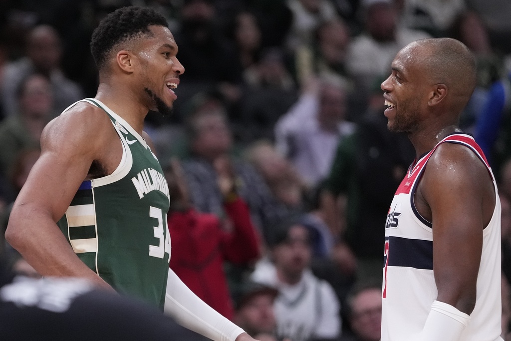 Milwaukee Bucks' Giannis Antetokounmpo and Washington Wizards' Khris Middleton share a laugh during the second half of an NBA basketball game Wednesday, Oct. 22, 2025, in Milwaukee. (AP Photo/Morry Gash)