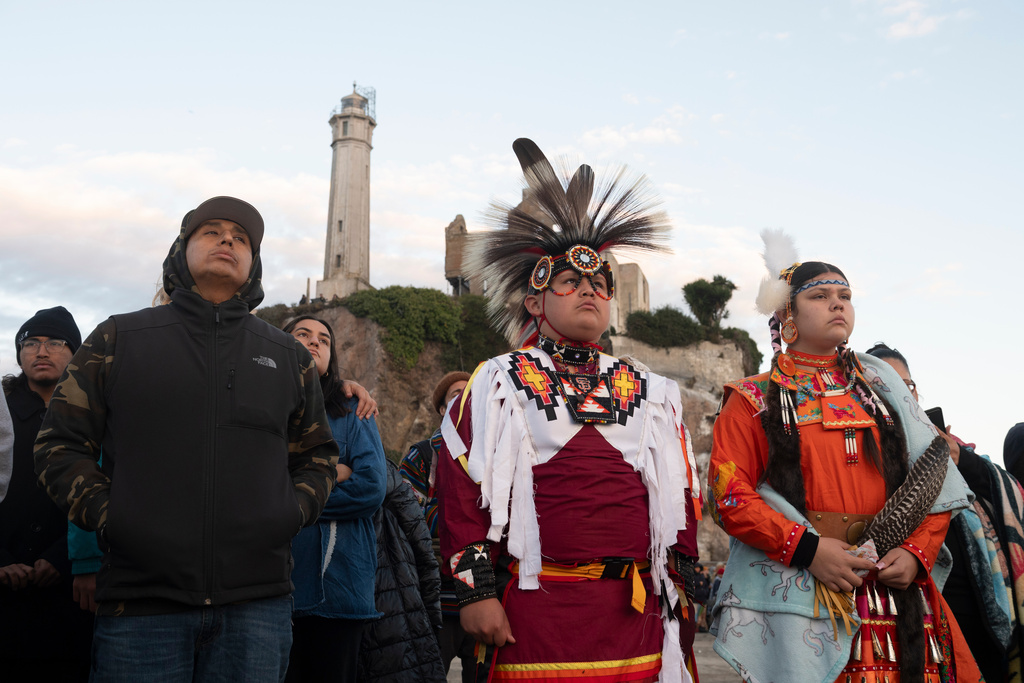 People watch the sun rise during a gathering on Indigenous Peoples Day on Alcatraz Island on Monday, Oct. 13, 2025, in San Francisco. (AP Photo/Laure Andrillon)