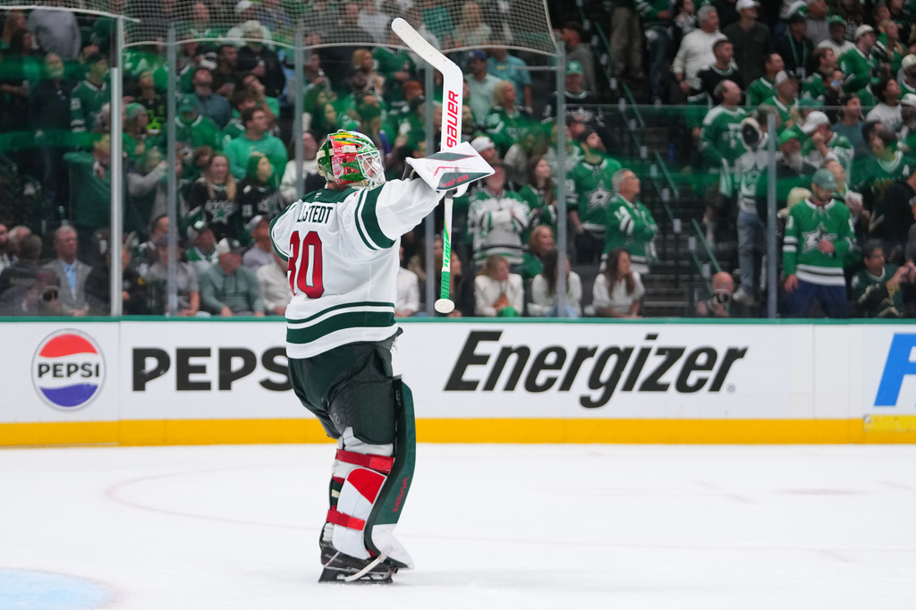 Minnesota Wild goaltender Jesper Wallstedt reacts to an open net goal by teammate left wing Kirill Kaprizov against the Dallas Stars during the third period in Game 5 of a first-round NHL Stanley Cup playoffs hockey series, Tuesday, April 28, 2026, in Dallas. (AP Photo/Julio Cortez)
