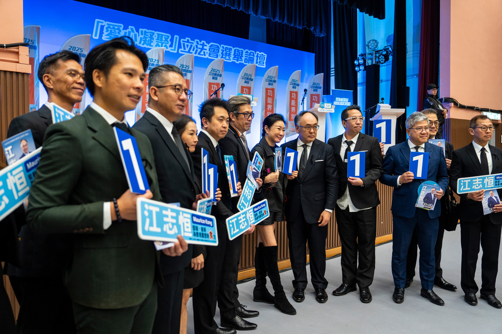 Kong Chi Hang, fifth from right, candidate of the Legislative Council Catering functional constituency election, poses for photographs with supporters at a forum in Hong Kong on Wednesday, Dec. 3, 2025. (AP Photo/Chan Long Hei)