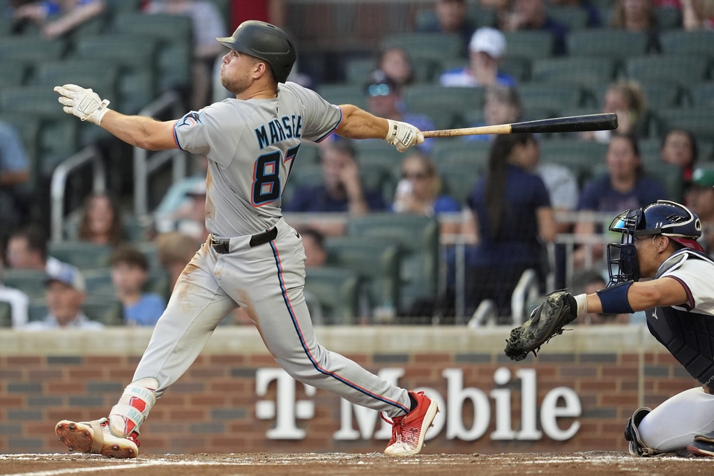 Miami Marlins outfielder Jakob Marsee (87) hits a single in the third inning of a baseball game against the Atlanta Braves, Thursday, Aug. 7, 2025, in Atlanta. (AP Photo/Mike Stewart)
