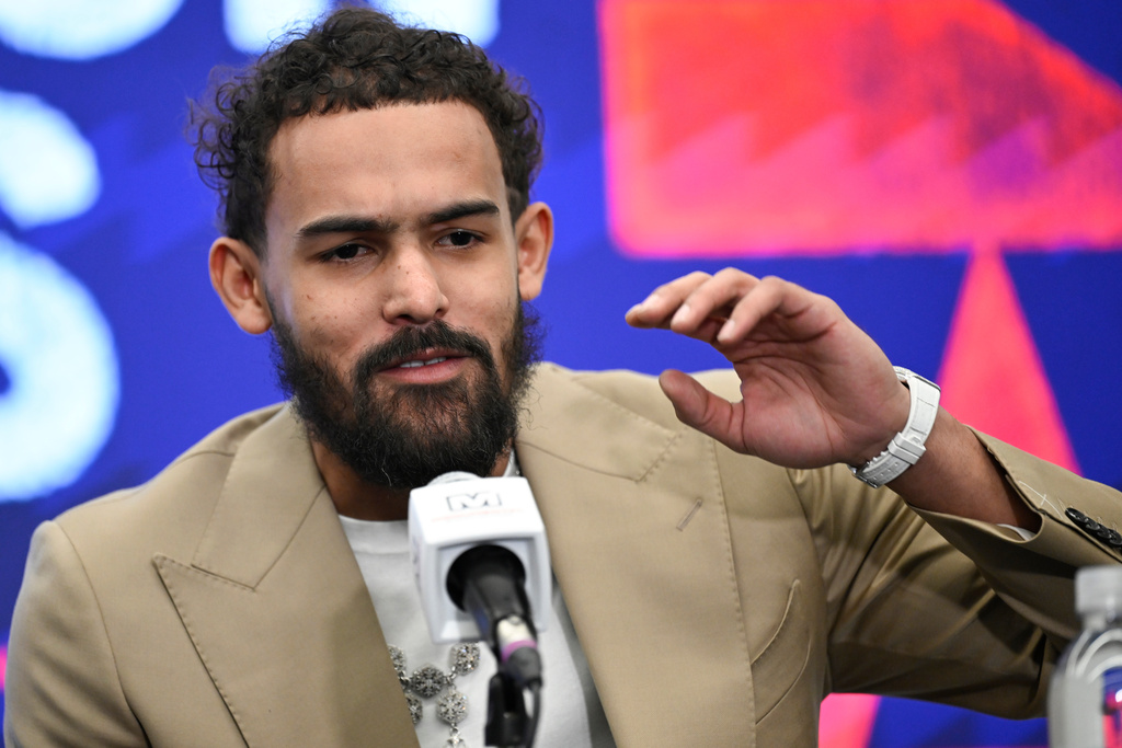 Washington Wizards newly acquired point guard Trae Young answers a question at news conference before an NBA basketball game against the New Orleans Pelicans, Friday, Jan. 9, 2026, in Washington. (AP Photo/John McDonnell)