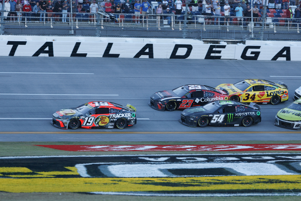 Chase Briscoe (19) leads the pack to the finish line for the win during a NASCAR Cup Series auto race at Talladega Superspeedway, Sunday, Oct. 19, 2025, in Talladega, Ala. (AP Photo/Butch Dill)