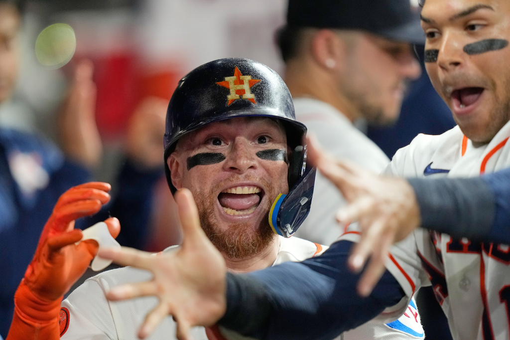 Houston Astros' Christian Vázquez, left, celebrates with Cam Smith in the dugout after hitting a home run against the Los Angeles Angels during the third inning of a baseball game Wednesday, Aug. 19, 2026, in Houston. (AP Photo/David J. Phillip)