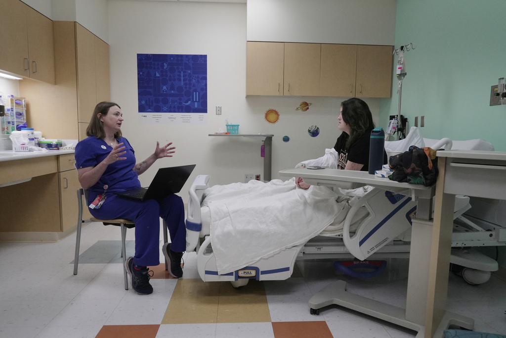 Dr. Melanie Cree explains medical results to Noelani Schulmeister in a study using GLP-1 medication to treat PMOS Friday, July 10, 2026 in Aurora, Colo. (AP Photo/Brittany Peterson)