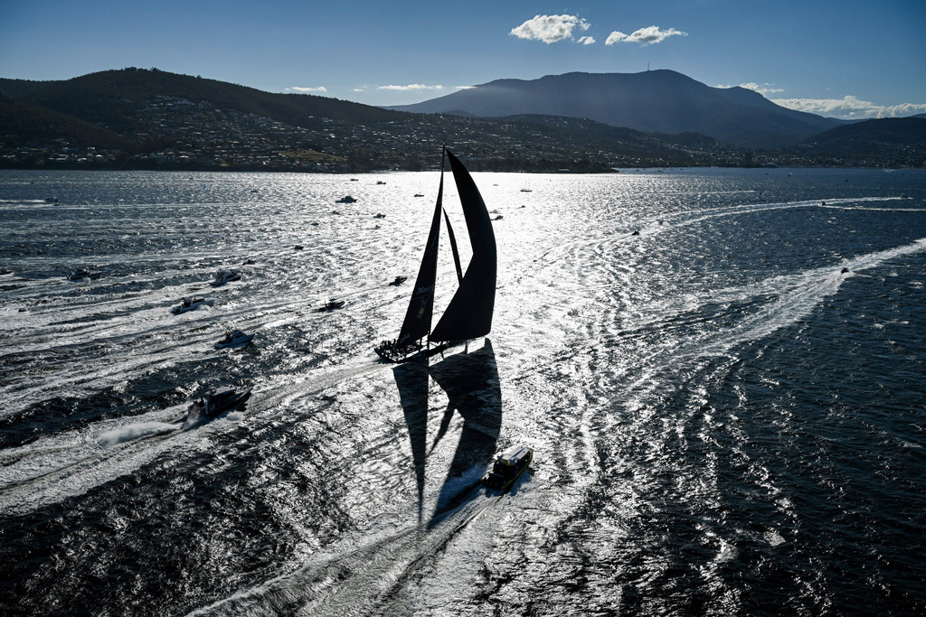 In this photo provided by the Cruising Yacht Club of Australia Comanche crosses the finish line in Hobart, Australia, Sunday, Dec. 28, 2025, to claim line honors in the Sydney Hobart yacht race. (Kurt Arrigo/CYCA via AP)
