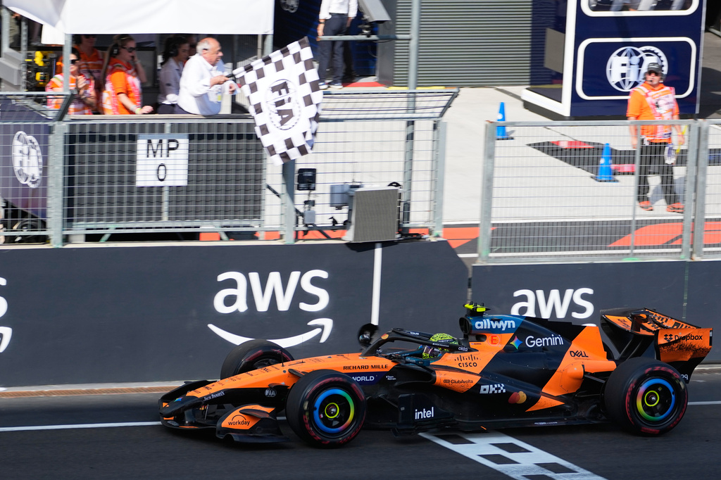 McLaren driver Lando Norris of Britain crosses the finish line to win the Formula One Hungarian Grand Prix auto race, at the Hungaroring racetrack in Mogyorod, near Budapest, Hungary, Sunday, July 26, 2026. (AP Photo/Darko Bandic)