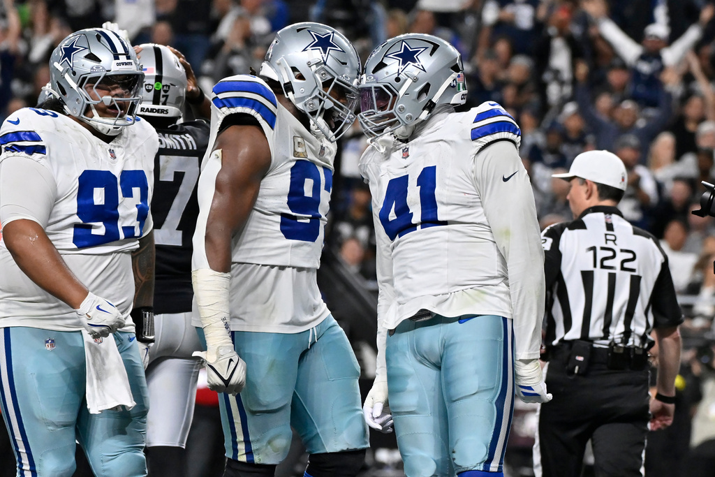 Dallas Cowboys defensive end Donovan Ezeiruaku (41) celebrates his safety against the Las Vegas Raiders with Cowboys defensive tackles Osa Odighizuwa, center, and Jay Toia (93) during the second half of an NFL football game Monday, Nov. 17, 2025, in Las Vegas. (AP Photo/David Becker)