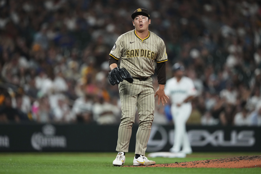 San Diego Padres relief pitcher Yuki Matsui reacts after catching a line drive from Seattle Mariners' J.P. Crawford during the seventh inning of a baseball game Monday, Aug. 25, 2025, in Seattle. (AP Photo/Lindsey Wasson)