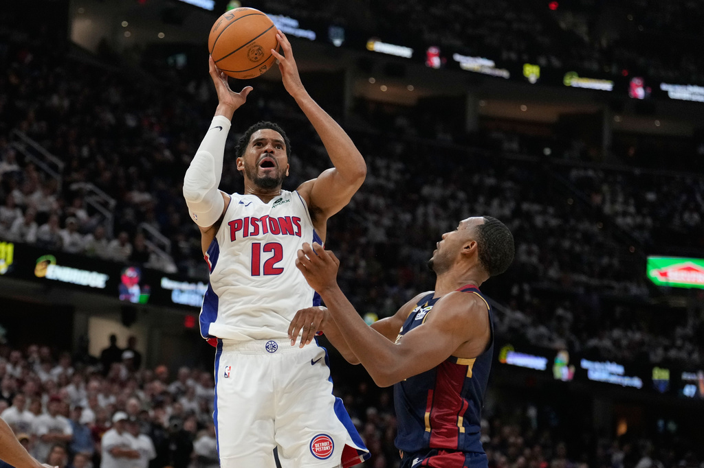 Detroit Pistons' Tobias Harris (12) shoots over Cleveland Cavaliers' Evan Mobley, right, in the second half of Game 4 of a second-round NBA basketball playoff series Monday, May 11, 2026, in Cleveland. (AP Photo/Sue Ogrocki)