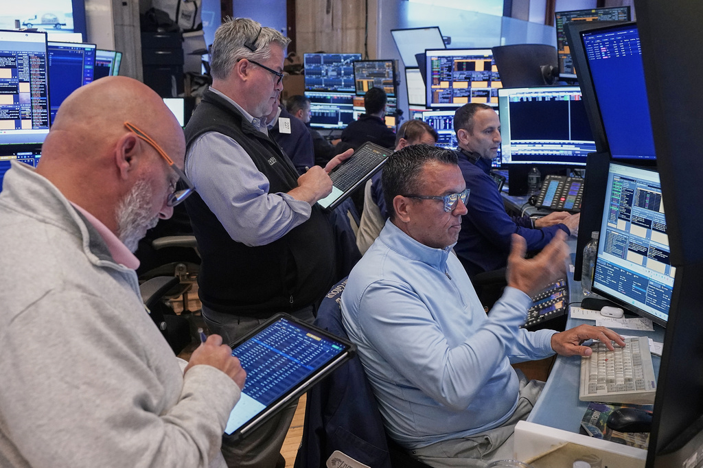 FILE - Robert Finnerty, Jr., foreground right, works with colleagues on the floor of the New York Stock Exchange, May 7, 2026. (AP Photo/Richard Drew, File)