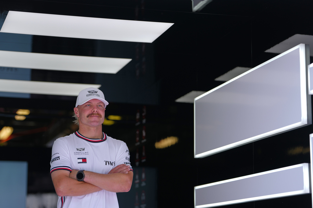 FILE - Cadillac driver Valtteri Bottas, of Finland, poses in his team garage ahead of the Australian Formula One Grand Prix at Albert Park, in Melbourne, Australia, Thursday, March 5, 2026. (AP Photo/Asanka Brendon Ratnayake, File)