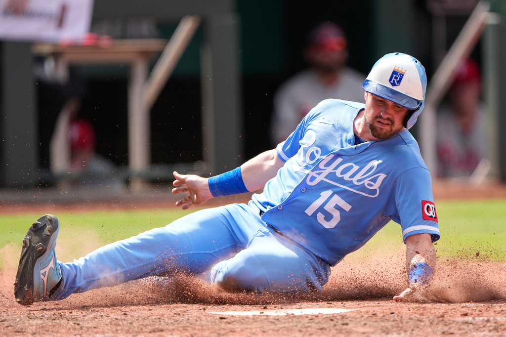 Kansas City Royals' Lane Thomas slides home to score on a two-run double hit by Salvador Perez during the eighth inning of a baseball game against the Philadelphia Phillies, Sunday, July 5, 2026, in Kansas City, Mo. (AP Photo/Charlie Riedel)