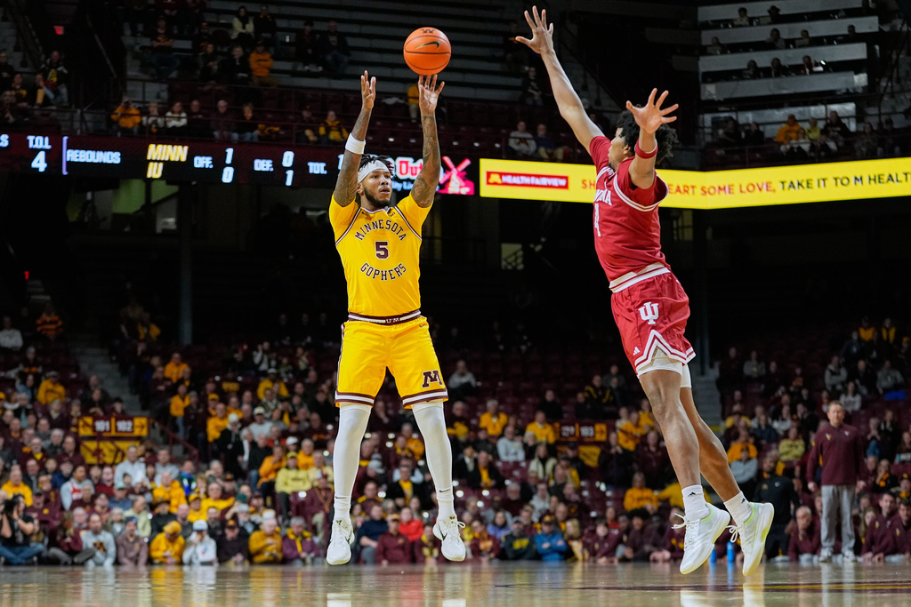 Minnesota forward Jaylen Crocker-Johnson (5) shoots over Indiana forward Sam Alexis (4) during the first half of an NCAA college basketball game Wednesday, Dec. 3, 2025, in Minneapolis. (AP Photo/Abbie Parr)