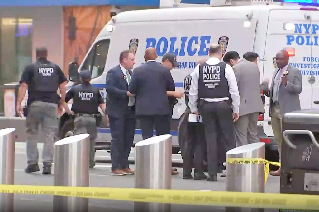 This image made from video provided by WABC shows NYPD officers on the scene after a woman brandishing two large knives was shot by officers in Times Square in New York, Monday, Aug. 31, 2026. (WABC via AP)