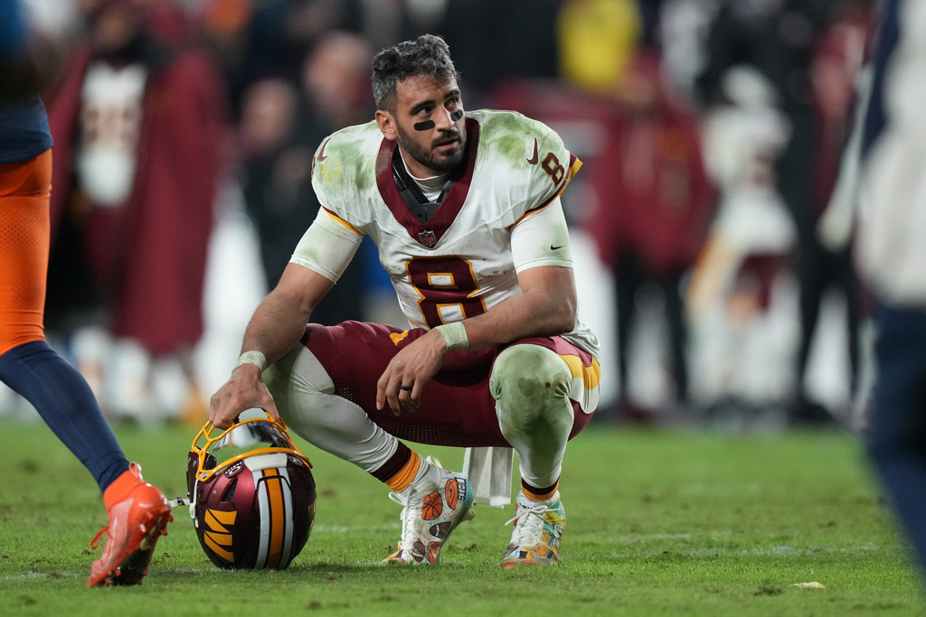 Washington Commanders quarterback Marcus Mariota (8) reacts after losing to the Denver Broncos in overtime of an NFL football game Monday, Dec. 1, 2025, in Landover, Md. (AP Photo/Stephanie Scarbrough)