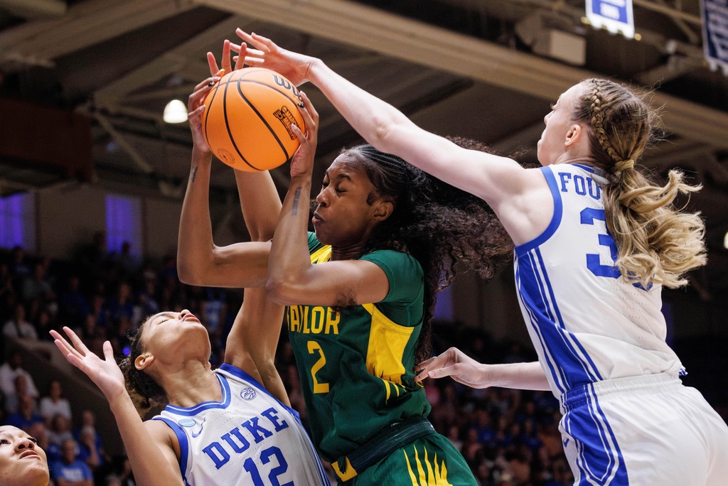 Baylor's Kiersten Johnson (2) grabs a rebound between Duke's Delaney Thomas (12) and Duke's Toby Fornier (35) during the first half in the second round of the NCAA college basketball tournament, Sunday, March 22, 2026 in Durham, N.C. (AP Photo/Ben McKeown)
