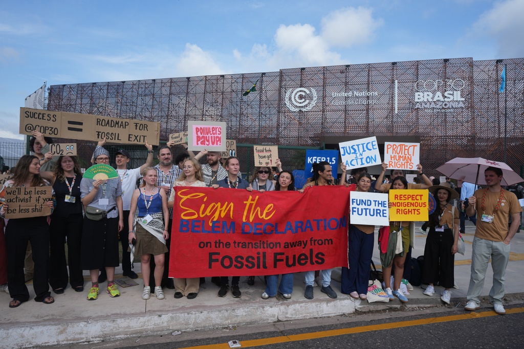 Activists participate in a demonstration to transition away from fossil fuels outside the venue for the COP30 U.N. Climate Summit, Wednesday, Nov. 19, 2025, in Belem, Brazil. (AP Photo/Andre Penner)