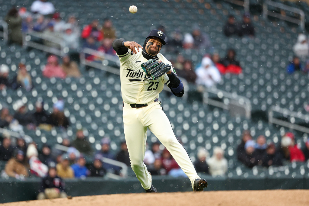 Minnesota Twins third baseman Royce Lewis throws to first base on a ball hit by Tampa Bay Rays' Chandler Simpson who was safe on the play during the second inning of baseball game, Saturday, April 4, 2026, in Minneapolis. (AP Photo/Matt Krohn)