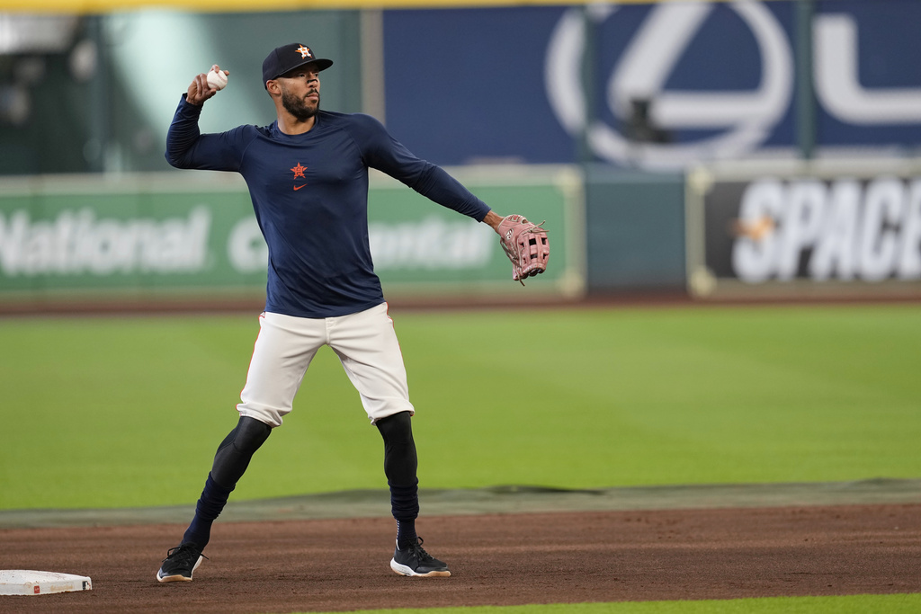 Houston Astros third baseman Carlos Correa throws during batting practice before a baseball game against the Boston Red Sox Monday, Aug. 11, 2025, in Houston. (AP Photo/David J. Phillip)