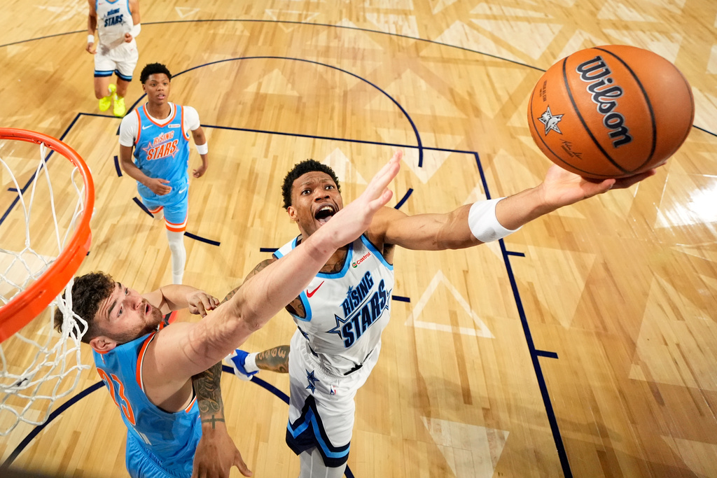 Team Austin guard Alijah Martin (55) of the Toronto Raptors, right, shoots as Team Melo frontcourt Donovan Clingan (23) of the Portland Trail Blazers defends during an NBA basketball's Rising Stars event Friday, Feb. 13, 2026, in Inglewood, Calif. (AP Photo/Mark J. Terrill)