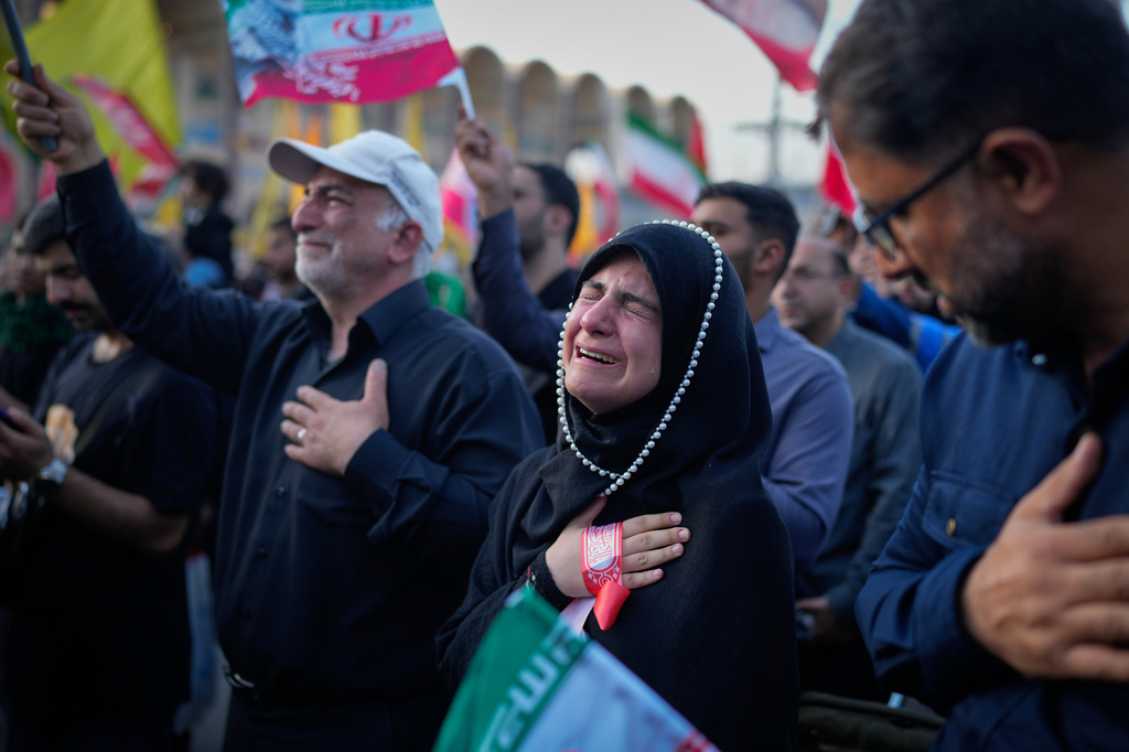 A woman weeps at the Imam Khomeini Mosalla Grand Mosque during funeral ceremonies for the slain Iranian Supreme Leader Ayatollah Ali Khamenei and members of his family in Tehran, Iran, Sunday, July 5, 2026. (AP Photo/Altaf Qadri)