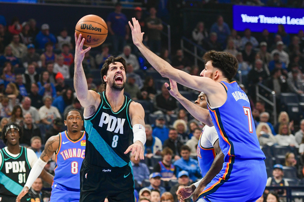 Portland Trail Blazers forward Deni Avdija (8) shoots over Oklahoma City Thunder center Chet Holmgren (7) during the first half of an NBA basketball game, Wednesday, Dec. 31, 2025, in Oklahoma City. (AP Photo/Kyle Phillips)
