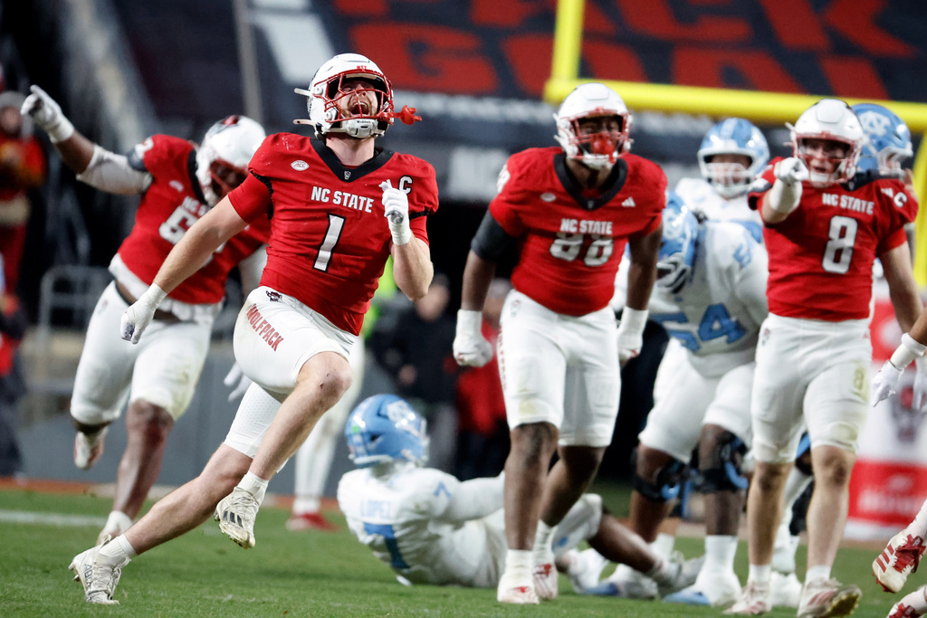 North Carolina State's Caden Fordham (1) celebrates after a sack against North Carolina quarterback Gio Lopez (7) during the first half of an NCAA college football game in Raleigh, N.C., Saturday, Nov. 29, 2025. (AP Photo/Karl DeBlaker)